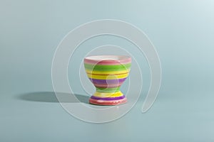 Striped egg cup on a green background