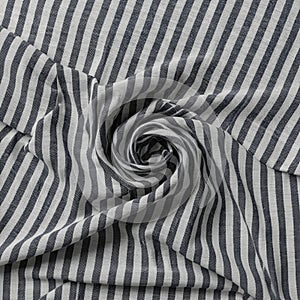 Striped fabric featuring a pattern of alternating black and white vertical lines. The fabric