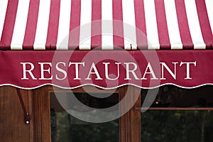 Striped french restaurant entrance canopy, Paris france.