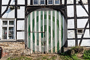 Striped gate in an old German half-timbered farmhouse on the outskirts of Hattingen, North Rhine-Westphalia, Germany