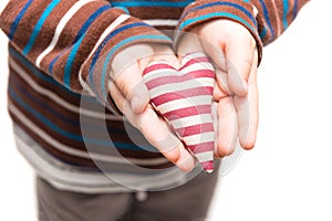 Striped heart in hands of little kid