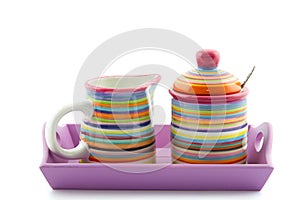Striped milk jug and sugar bowl on a serving-tray