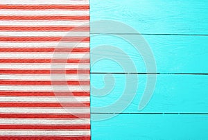 Striped napkin on blue wooden table. Top view and mock up.