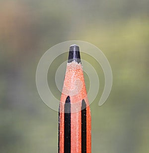 Striped pencil tip on blurred background macro
