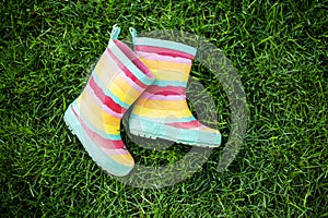 Striped rain boots on grass