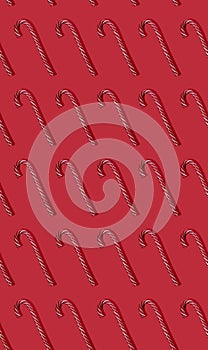 Striped red and white candy canes on red background. Trendy seamless pattern. Flat lay witn Cristmas lollipop hard light