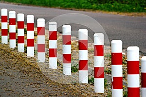 Striped red and white roadside safety posts