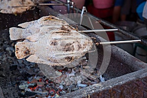 Striped snakehead fish grilled with salt. Pomegranate fish with salt and then burned for sales in the market. Thai style street f