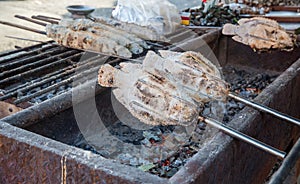 Striped snakehead fish grilled with salt. Pomegranate fish with salt and then burned for sales in the market. Thai style street f