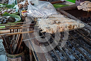 Striped snakehead fish grilled with salt. Pomegranate fish with salt and then burned for sales in the market. Thai style street f