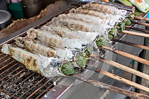 Striped snakehead fish grilled with salt. Pomegranate fish with salt and then burned for sales in the market. Thai style street f