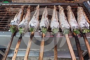 Striped snakehead fish grilled with salt. Pomegranate fish with salt and then burned for sales in the market. Thai style street f