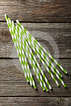 Striped straws for cocktails on a grey wooden background