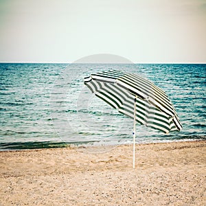 Striped Umbrella On Sandy Beach