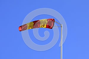 Striped Windsock against Clear Blue Sky