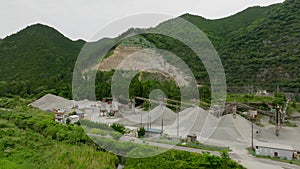 Stripped mountain forest and material piles at open pit mine