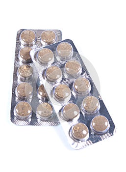 Strips of brown colored medicine tablet blisters. photo
