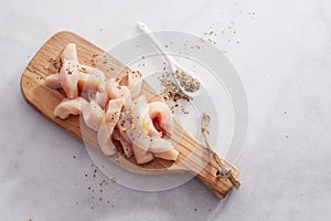 Strips of lean healthy uncooked chicken breast