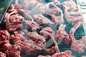 Strips of meat cooking in a barbecue