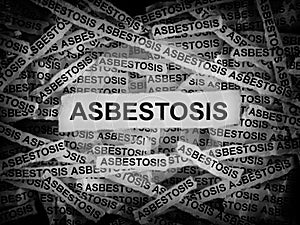 Strips of newspaper with the word Asbestosis typed on them. Black and white