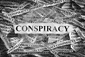 Strips of newspaper with the word Conspiracy typed on them