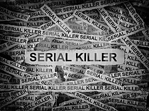 Strips of newspaper with the words Serial Killer typed on them. Black and white
