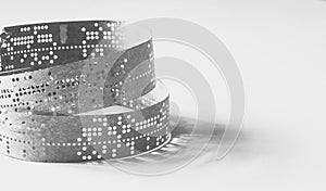 Strips of old punched tape on a white surface