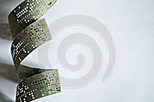 Strips of old punched tape on a white surface