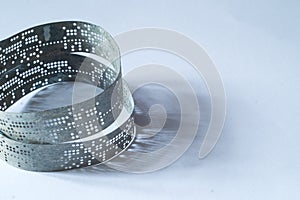 Strips of old punched tape on a white surface