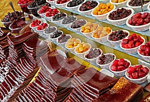 Strips of Processed Sour Fruits and Bowls of Traditionally Dried Plums and Cherries in Iran photo