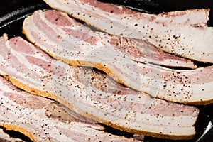 Strips of raw bacon ready to fry