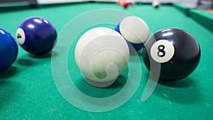 Strips and solds balls on green pool table