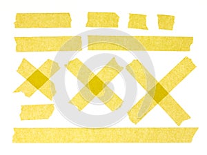 Strips of yellow masking tape on white background. Set of adhesive tape strips and crosses. Painter`s tape isolated on white