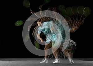 Stroboscope effect. One man, professional tennis player  on black background in mixed neon light.