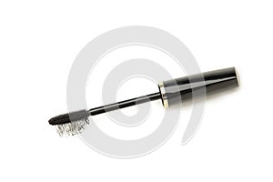 Stroke of black mascara with applicator brush close-up, isolated on white background