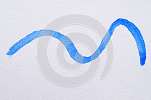 Stroke of blue watercolor paint on white background, top view