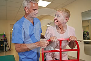 Stroke patient using walking frame in medical clinic