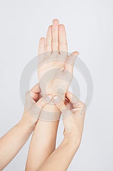 Stroking massage of hands close up on a white background