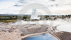 Strokkur geyser eruption and Geysir in Haukadalur