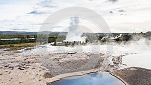 Strokkur geyser eruption and pool of Geysir