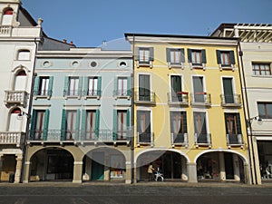 Stroller Beneath Portico in Italian Piazza