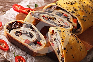 Stromboli stuffed with wild mushrooms and pepper close-up