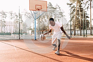 Strong African young sports people in the stadium in the open air to play basketball