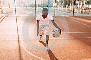 Strong African young sports people in the stadium in the open air to play basketball