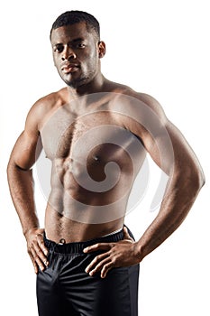 Strong afro-american handsome guy with hands on the hips loking at the camera