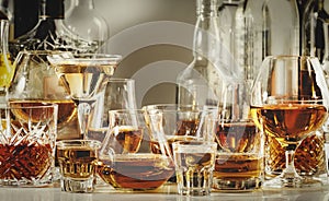 Strong alcohol drinks, hard liquors, spirits and distillates iset in glasses and bottles: cognac, scotch, whiskey and other. Black