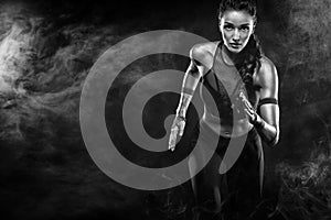 A strong athletic, woman sprinter, running on black background wearing in the sportswear, fitness and sport motivation