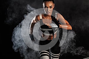 A strong athletic, female sprinter, running at sunrise wearing in the sportswear, fitness and sport motivation concept