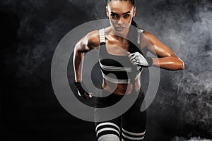 A strong athletic, female sprinter, running at sunrise wearing in the sportswear, fitness and sport motivation concept