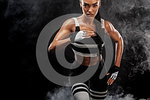 A strong athletic, female sprinter, running at sunrise wearing in the sportswear, fitness and sport motivation concept